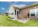 Outdoor patio with a table, chairs, and grill surrounded by a well-manicured lawn at 4291 Washington Blvd, Plainfield, IN 46168