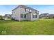 A grassy backyard featuring a two-story home, showing the exterior siding and well-maintained lawn at 4416 Eaglecrest Pl, Zionsville, IN 46077