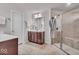 Well-lit bathroom with ceramic tile flooring, a double vanity, and a modern shower at 4416 Eaglecrest Pl, Zionsville, IN 46077