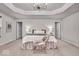 Spacious bedroom with tray ceilings, stylish chandelier, and neutral tones create a serene and elegant ambiance at 4416 Eaglecrest Pl, Zionsville, IN 46077