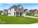 Stunning two-story home with stone accents, well-maintained lawn, and a cozy front porch at 4416 Eaglecrest Pl, Zionsville, IN 46077