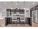 Modern kitchen featuring dark cabinets, stainless steel appliances, granite countertops, and a large island with seating at 4416 Eaglecrest Pl, Zionsville, IN 46077