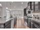 Modern kitchen with stainless steel appliances, dark cabinets, granite countertops, and breakfast bar seating at 4416 Eaglecrest Pl, Zionsville, IN 46077