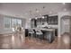 Modern kitchen with dark cabinets, stainless appliances, granite counters, island seating and adjacent dining area at 4416 Eaglecrest Pl, Zionsville, IN 46077