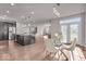 Open-concept kitchen featuring a large island, stainless appliances, and a nearby dining area with french doors at 4416 Eaglecrest Pl, Zionsville, IN 46077