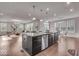 Open-concept kitchen with stainless steel appliances, dark cabinets, granite countertops, and a large island at 4416 Eaglecrest Pl, Zionsville, IN 46077