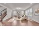 Bright living room boasts hardwood floors, lots of natural light, and neutral decor at 4416 Eaglecrest Pl, Zionsville, IN 46077