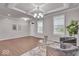 Bright living area with a coffered ceiling, stylish armchairs, a glass table, and wood-look floors at 4416 Eaglecrest Pl, Zionsville, IN 46077