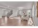 Bright living room featuring a staircase, hardwood floors, neutral decor, and large windows at 4416 Eaglecrest Pl, Zionsville, IN 46077