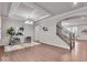 Open-concept living space with hardwood floors, staircase, elegant furnishings, and stylish decor at 4416 Eaglecrest Pl, Zionsville, IN 46077