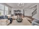 Open-concept living room with contemporary furnishings, abundant natural light, and an open view to the kitchen at 4416 Eaglecrest Pl, Zionsville, IN 46077