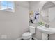 Powder room with a pedestal sink, white toilet and framed wall art at 4416 Eaglecrest Pl, Zionsville, IN 46077
