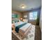 Serene bedroom featuring a queen size bed, dresser, decor and large window with natural light at 5011 Amber Creek Pl # 205, Indianapolis, IN 46237