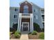 Charming condo building with red brick facade, blue siding and well maintained landscaping at 5011 Amber Creek Pl # 205, Indianapolis, IN 46237