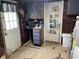 Unfinished basement with storage cabinets and a door leading to outside and lots of storage space at 5091 Alexandria Pike, Anderson, IN 46012