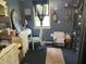 Bedroom featuring a natural light from the window, blue painted walls, and a neutral-colored rug at 5091 Alexandria Pike, Anderson, IN 46012