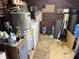 Utility room showcasing updated mechanicals, a washer, and a brick accent wall at 5091 Alexandria Pike, Anderson, IN 46012