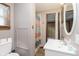 Cozy bathroom features a shower with colorful curtains, tile floor, and vanity at 5110 S State Ave, Indianapolis, IN 46227