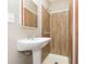Traditional bathroom with a pedestal sink and shower, blending classic charm with functionality at 5110 S State Ave, Indianapolis, IN 46227