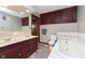 Well-lit bathroom with double sinks, soaking tub and classic fixtures at 5110 S State Ave, Indianapolis, IN 46227