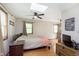 Bright bedroom features a ceiling fan, hardwood floors, and skylight at 5110 S State Ave, Indianapolis, IN 46227