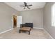 Neutral bedroom with ceiling fan features carpet, sofa, and a center table at 5110 S State Ave, Indianapolis, IN 46227