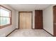 Carpeted bedroom features a closet with sliding doors and built-in shelving at 5110 S State Ave, Indianapolis, IN 46227