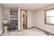 Carpeted room features a desk, chair, and a doorway to a bathroom at 5110 S State Ave, Indianapolis, IN 46227