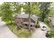 Charming brick home with a covered front porch and mature trees providing ample shade at 5110 S State Ave, Indianapolis, IN 46227