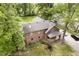 Rear aerial view showing brickwork, new roof, and covered porch, plus mature landscaping at 5110 S State Ave, Indianapolis, IN 46227