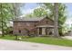 Charming two-story brick home with a cozy front porch and mature trees, offering classic curb appeal at 5110 S State Ave, Indianapolis, IN 46227