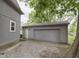 A one-car detached garage with gray paint in a well-kept backyard setting at 5110 S State Ave, Indianapolis, IN 46227
