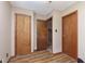 Inviting hallway with wood floors and multiple doors, creating a warm and welcoming atmosphere at 5110 S State Ave, Indianapolis, IN 46227