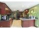 Charming kitchen with dark wood cabinets, tiled floor, and modern fixtures creates a functional space at 5110 S State Ave, Indianapolis, IN 46227