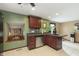 Functional kitchen with dark wood cabinets, stainless steel appliances, and a pass-through window to the living area at 5110 S State Ave, Indianapolis, IN 46227