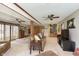 Spacious living room with neutral carpet, ceiling fans, and sliding glass doors, perfect for Gathering gatherings at 5110 S State Ave, Indianapolis, IN 46227