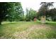 Expansive yard with mature trees, a shed, and an outhouse, ideal for outdoor enjoyment at 5116 W County Road 450 S, Coatesville, IN 46121