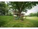 Backyard area featuring a custom treehouse, providing a unique and fun recreational space at 5116 W County Road 450 S, Coatesville, IN 46121