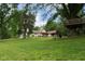 Beautiful lawn with mature trees and treehouse, creating a serene outdoor environment at 5116 W County Road 450 S, Coatesville, IN 46121