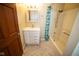 Updated bathroom with a tiled floor, a shower with new shower curtain, and vanity with storage at 5116 W County Road 450 S, Coatesville, IN 46121