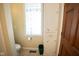 Bathroom featuring a toilet, new paint, storage cabinet, and natural light from the privacy glass window at 5116 W County Road 450 S, Coatesville, IN 46121