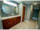 A bathroom features a dual sink vanity with modern fixtures, complemented by sleek mosaic tile accents at 5116 W County Road 450 S, Coatesville, IN 46121