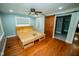 Bedroom with a ceiling fan and a wooden sliding barn door providing natural light and charm at 5116 W County Road 450 S, Coatesville, IN 46121