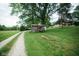 Picturesque gravel driveway lined with trees and leading to the property's outbuildings at 5116 W County Road 450 S, Coatesville, IN 46121
