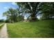 Wide view of property, with house, treehouse, outbuilding, and expansive lawn at 5116 W County Road 450 S, Coatesville, IN 46121
