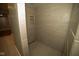 A walk-in shower features sleek, light-colored tile, providing a modern, spa-like experience at 5116 W County Road 450 S, Coatesville, IN 46121