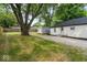 A spacious backyard offers a serene setting with lush grass and a storage shed for added convenience at 5136 Miller St, Indianapolis, IN 46241