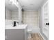 Updated bathroom features tile surround, vanity, and built in storage at 5136 Miller St, Indianapolis, IN 46241
