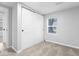 Carpeted bedroom with window and double door closet at 5136 Miller St, Indianapolis, IN 46241