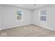 Carpeted bedroom with two windows at 5136 Miller St, Indianapolis, IN 46241